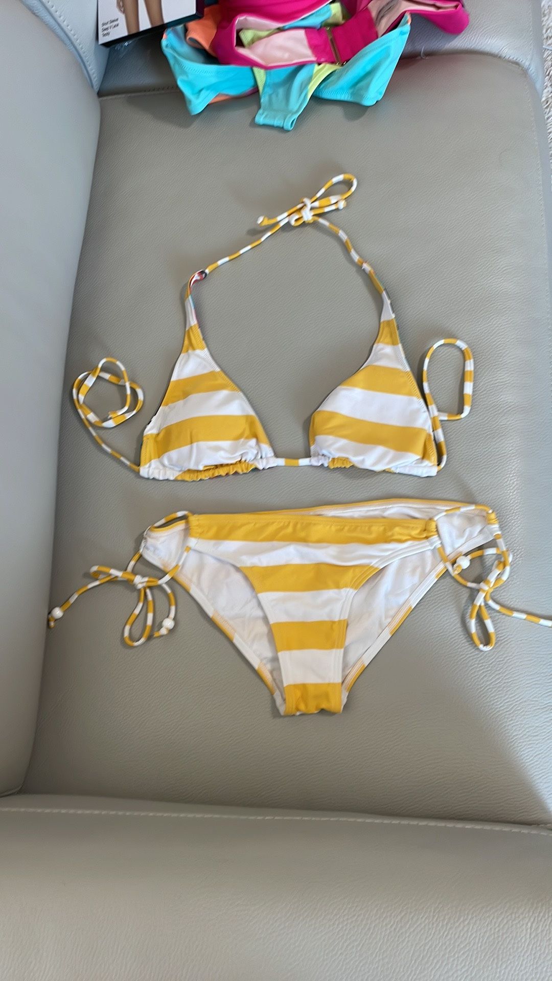 Ripcurl swimsuit 2 piece bikini yellow white stripe medium bottom with side tie 34C triangle top. Top has two sides. Worn a few times