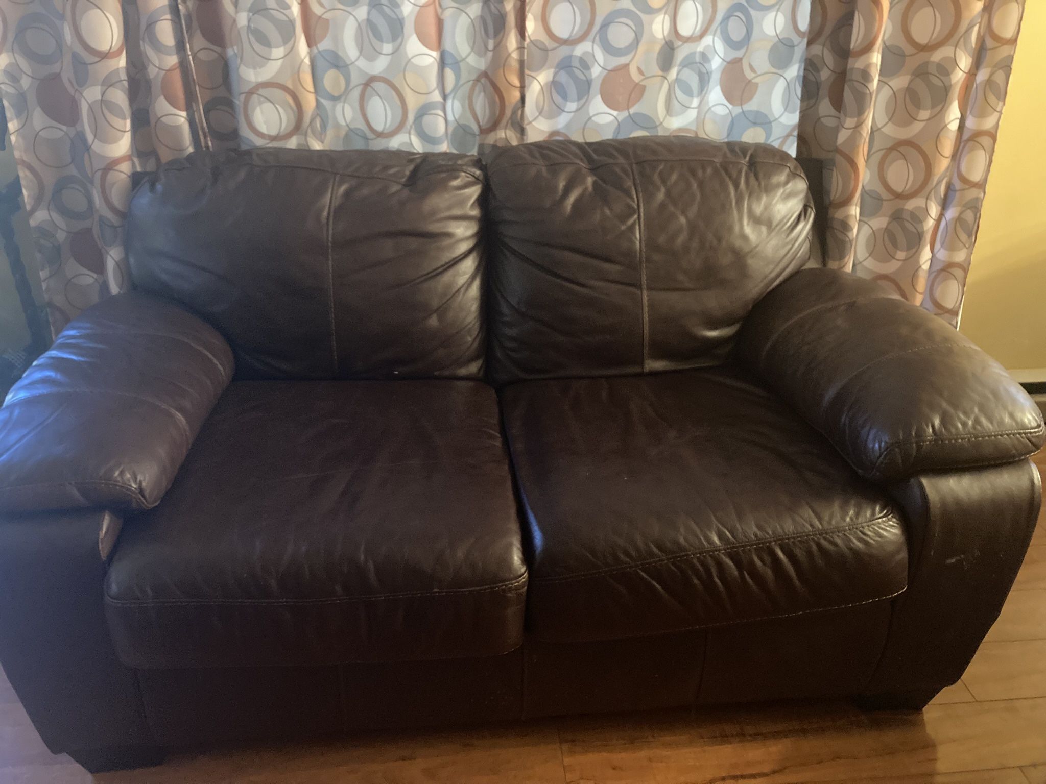 Brown leather Ashley loveseat