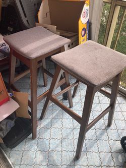 Two fair condition solid wood stools for $10 both high bar stools