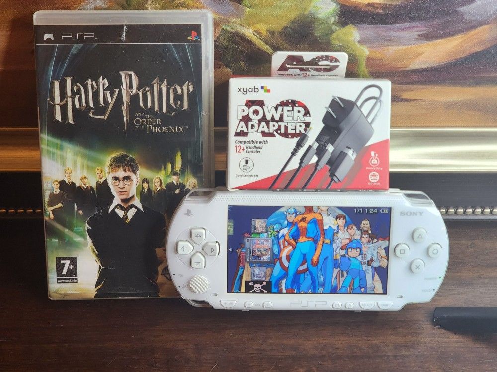 WHITE PSP 1000 comes with a charger, 1 battery, Harry Pot,and 128 gb memory card