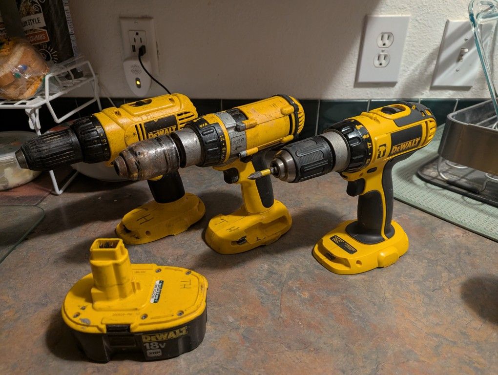 Three 18-volt dewalt power drills and one 18-volt battery