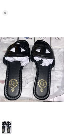 DF black slide mules with a sleek open-cutout upper.