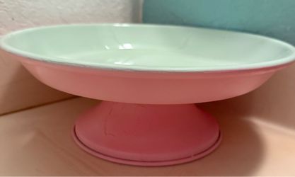 Pastel pink and light green footed dessert or cake stand with a shallow, wide bowl and a flared pedestal base