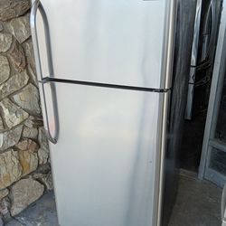 Frigidaire brand stainless steel apartment size refrigerator and top freezer