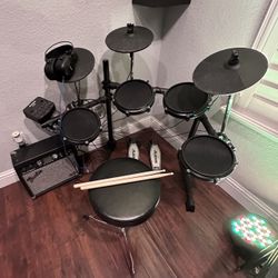 Alesis Drum set w/drumsticks,seat,headphones,amplifier