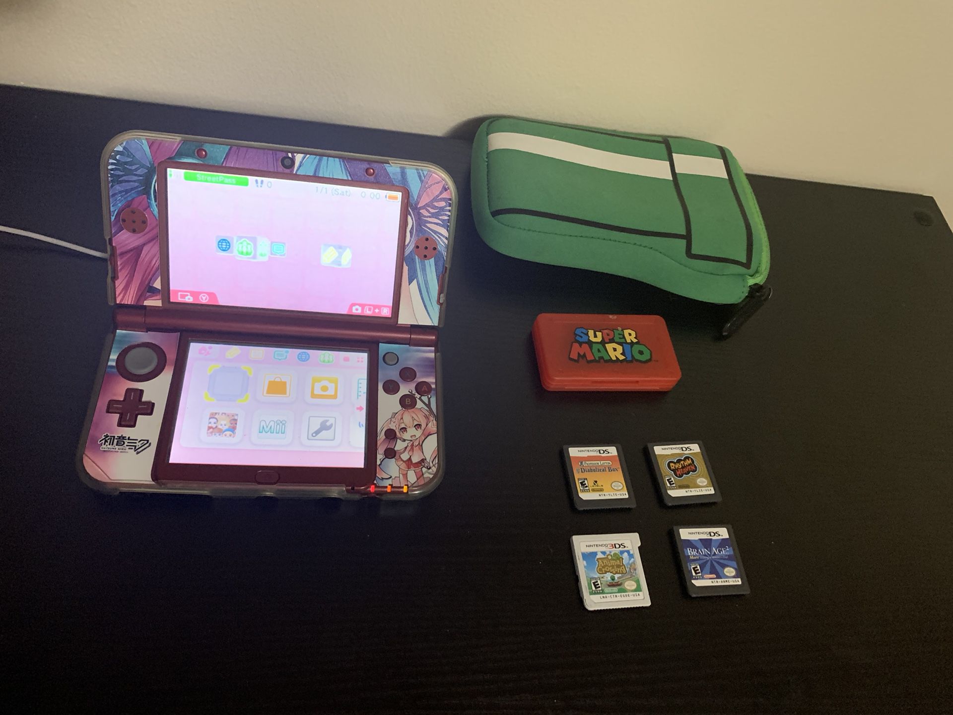 Nintendo 3DS XL with 4 games, charger and case