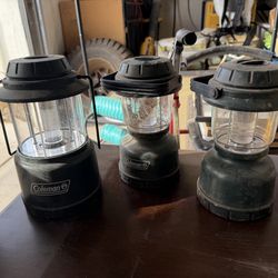 One collapsible and two normal Coleman outdoor battery powered lights