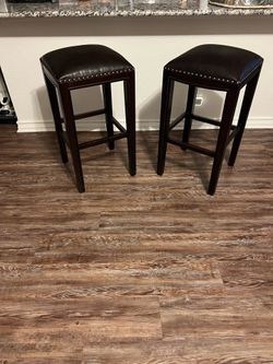 2 brown wood bar Stools