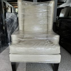 Elegant Beige Wingback Armchair with Nailhead Trim