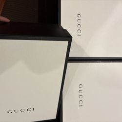 3 Gucci shoes boxes and 1 Gucci paper bag