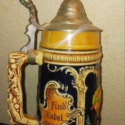 a vintage German beer stein or Krug with a pewter lid.