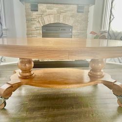 Golden Oak oval table with designer wooden casters