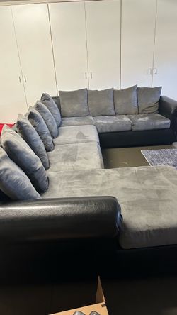 Used grey suede & black leather sectional