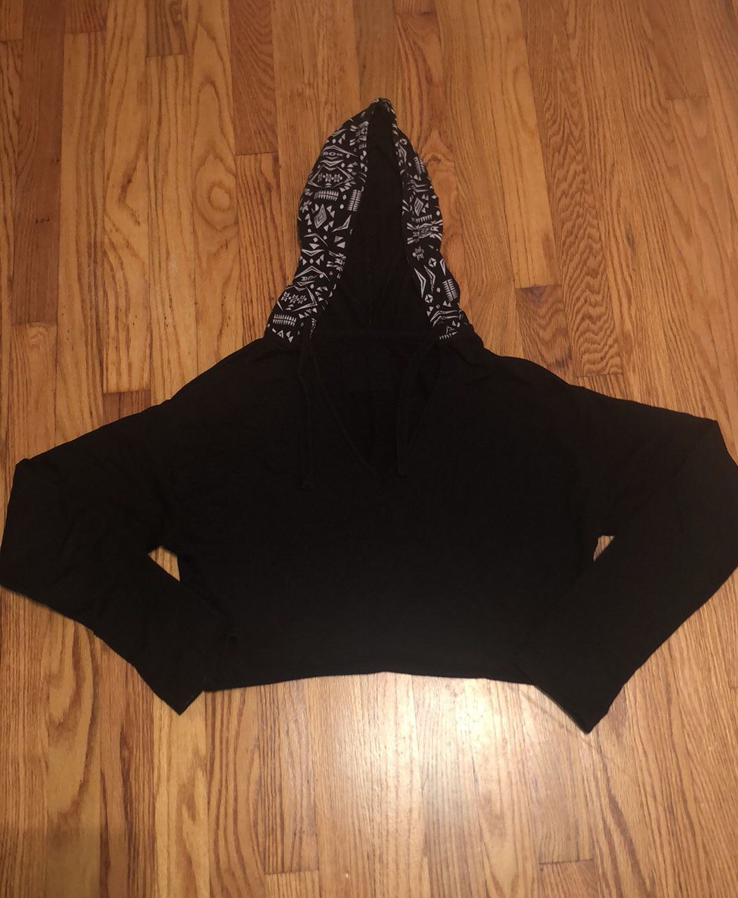 Size large black and white cropped hoodie. Has a small bleach spot on the sleeve. Not noticeable when wearing