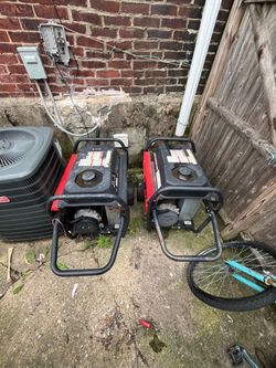 Two Red and Black Portable Gas Generators