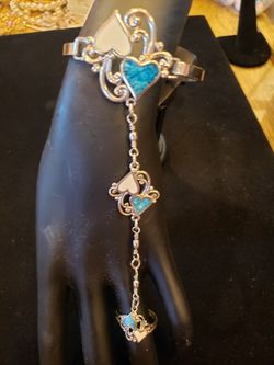 $18. Inlaid turquoise and white enamel heart link bracelet ring set. Silvertone. Bracelet fits up to 7.5-in wrist. Ring is size 9.5.