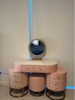 Pink make up table with some tear issues but you can’t see it