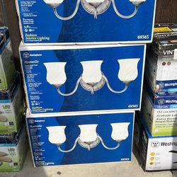 Lights Hyattsville 3-Light Vanity Fixtures (Model #69363) in an antique nickel finish with fro