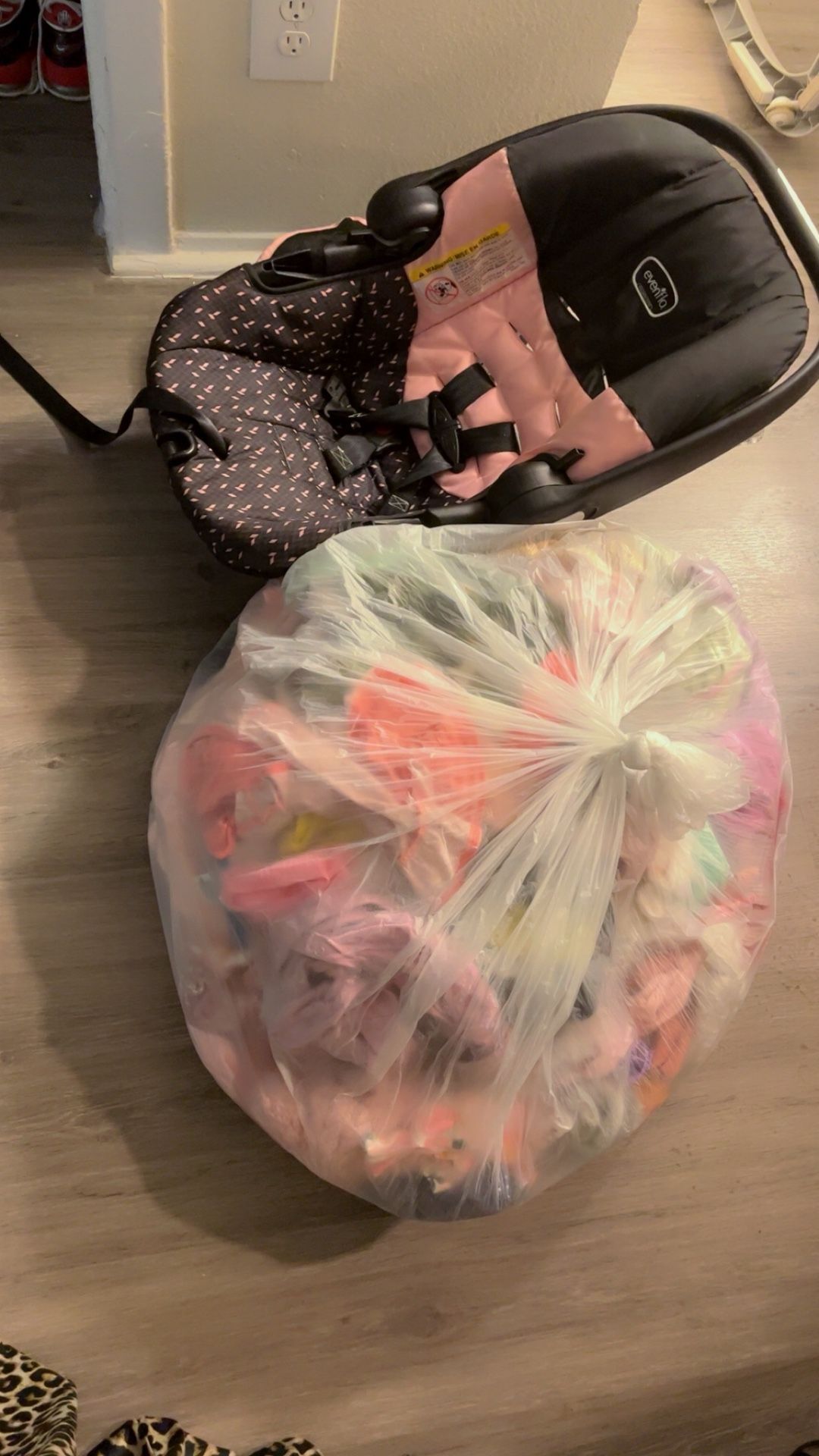 free bag of clothes and baby carrier