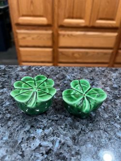 Vintage 1950’s Three & Four Leaf Clovers Ceramic Pair of Salt And Pepper Shakers. Size approximately 1 1/4 inches tall. Preowned the stoppers have b