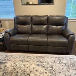 Leather two Recliner sofa. Purchased one year ago hardly used. Two photos show minor scratches.