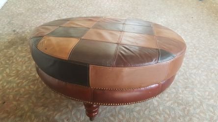 Very large round leather ottoman coffee table stool, one leg needs put back on, not a biggie. Secret zippered pouch underneath for your stash. 38"