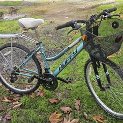 Huffy 18 Speed Mountain Bike W/ Basket, Front Shocks, and Back Luggage Support.