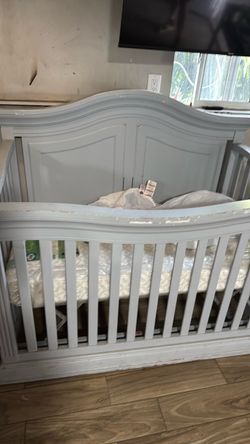 Crib with new mattress and diaper change