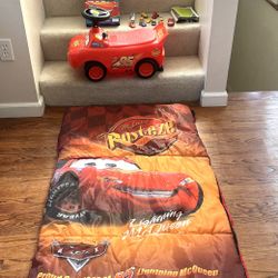 Pixar Cars Lot Of Toys & Items. Luggage, Sleeping Bag, Ride-On With Sounds & Lights, Busy Book & 12 Little Cars, Soft Lightning Mcqueen Car. ($45)