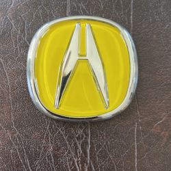Yellow Acura emblem