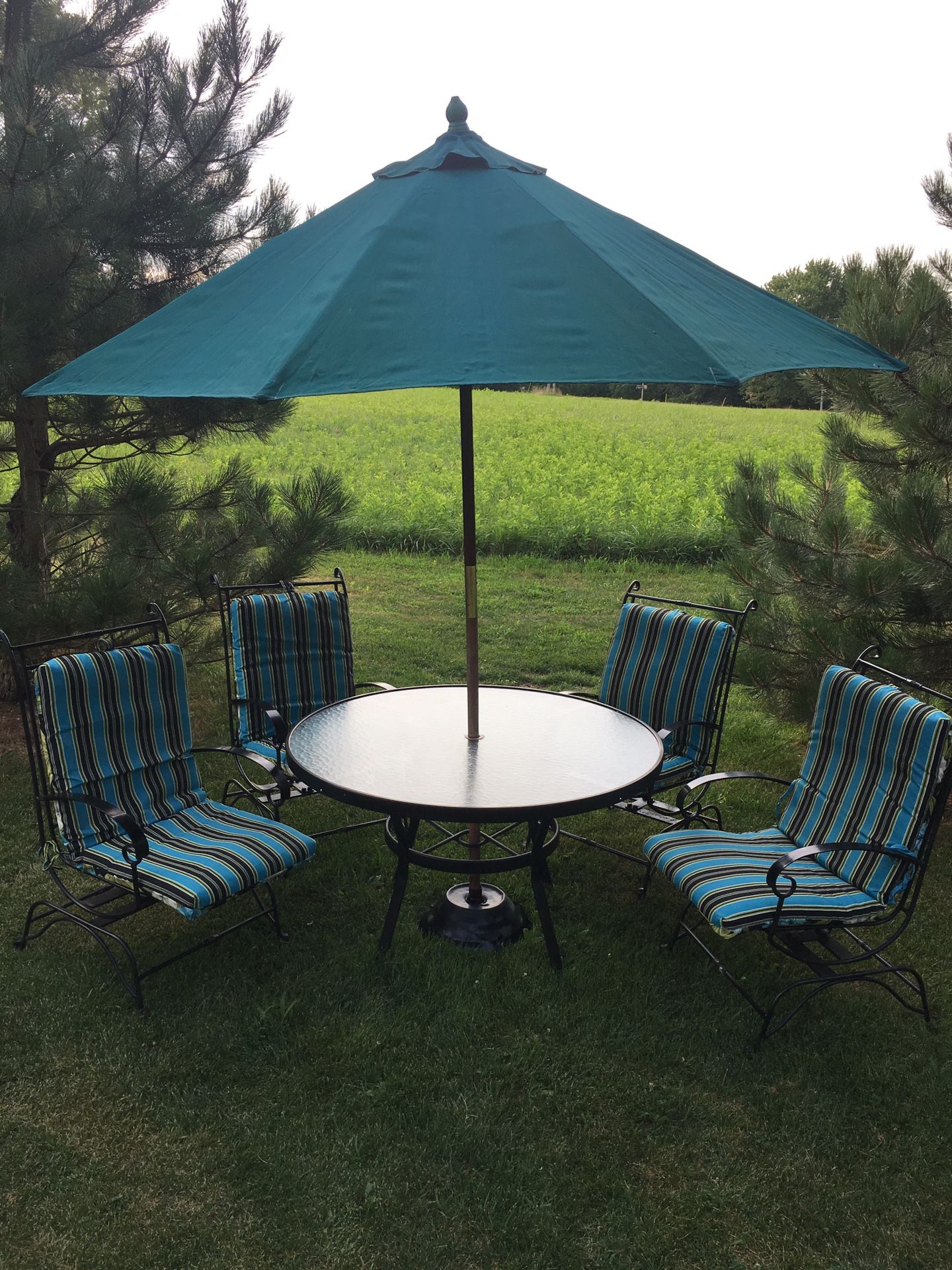 Patio set 11 pieces table for chairs market umbrella With stand and for a new reversible cushions made of metal very strong and chairs have a little