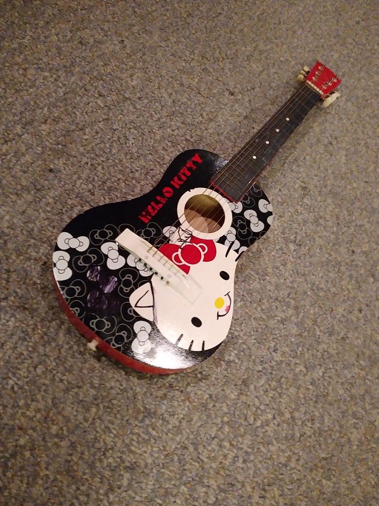 HELLO. KITTY GUITAR. ALL WOOD NO PLASTIC. 31 INCHES. LONG IN GREAT SHAPE. HARD TO FIND. 65 DOLLARS