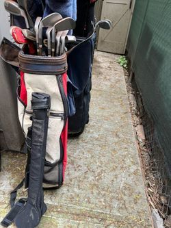Golf clubs , bags and a cart