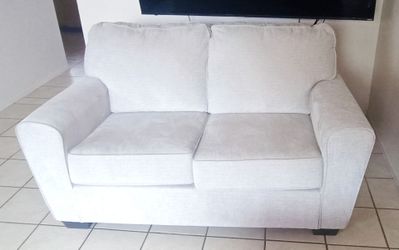Beige loveseat 62"W x 36"H x 37"D
