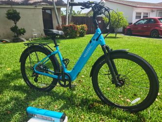 This is a brand new Velotric Breeze 1 electric bike that includes an extra battery and features a front air fork suspension with rear rack