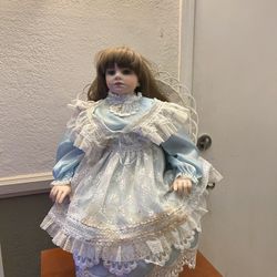 28” Porcelain Doll With Wicker Chair