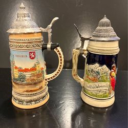 2 Vintage German Porcelain Beer Steins with Decorate Relief Designs and Hinged Pewter Lids