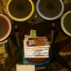 Nintendo Wii with drums 2 guitars & 6 games.