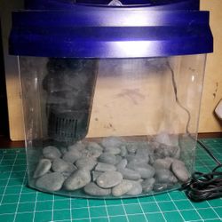 Blue Fish Tank with rocks and filter / light