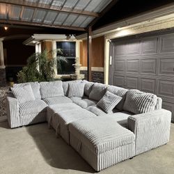 Beautiful lite grey modern sectional with pullout bed and storage and usb in great condition super soft and comfy asking 850