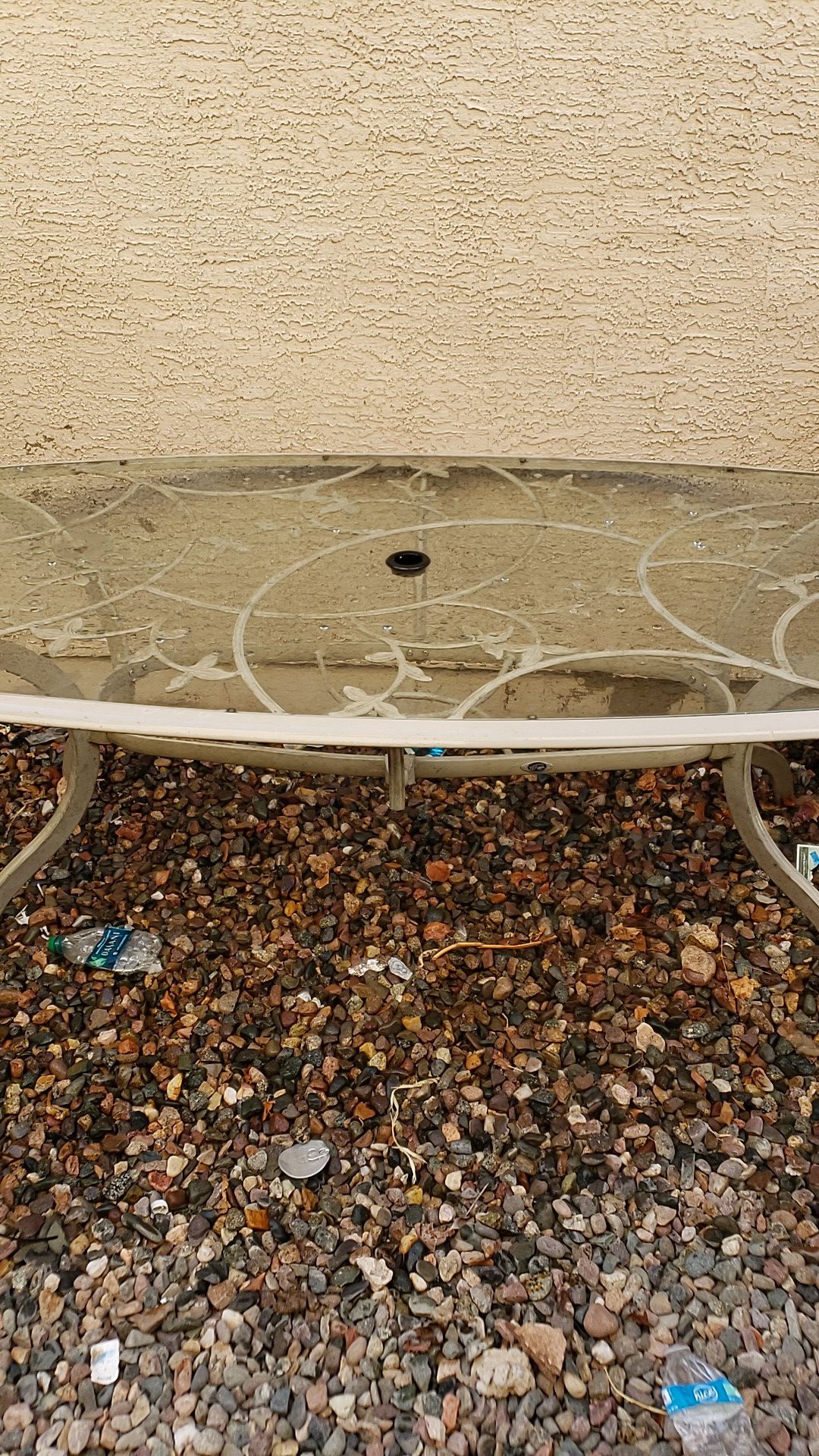 Glass top patio table with umbrella hole.