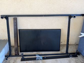 Free bed frame with black leather headboard.