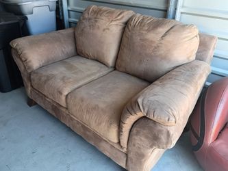 Tan n microfiber loveseat with plush cushions.