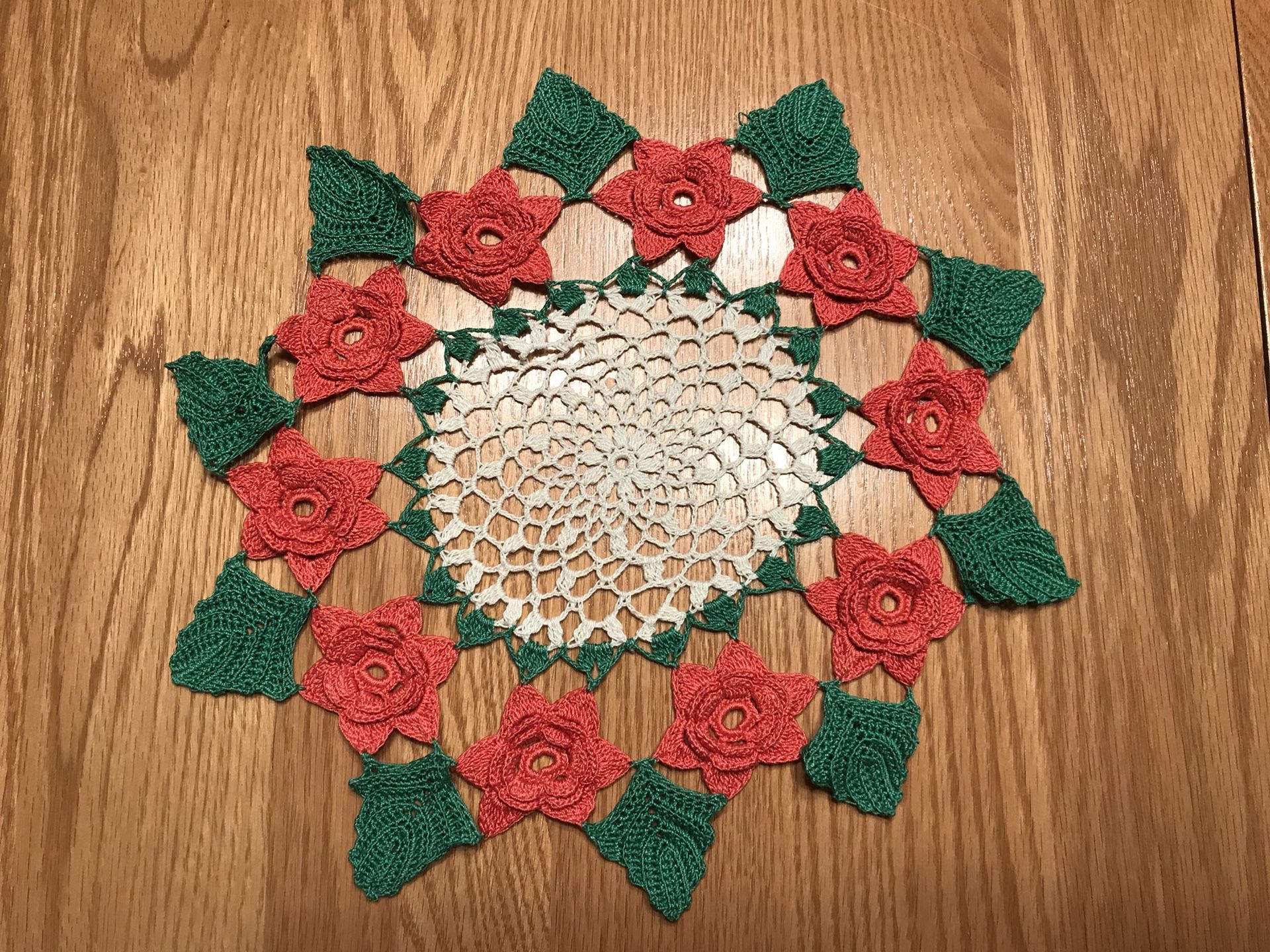 Vintage hand crocheted doily with 3D red roses