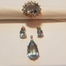 14 karat gold ring pendant and earrings set Ring have 16 diamonds around  Aquamarine stone in the center pendent and earring have one  Aquamarine Sto 
