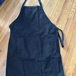 Black apron with adjustable straps and pockets 