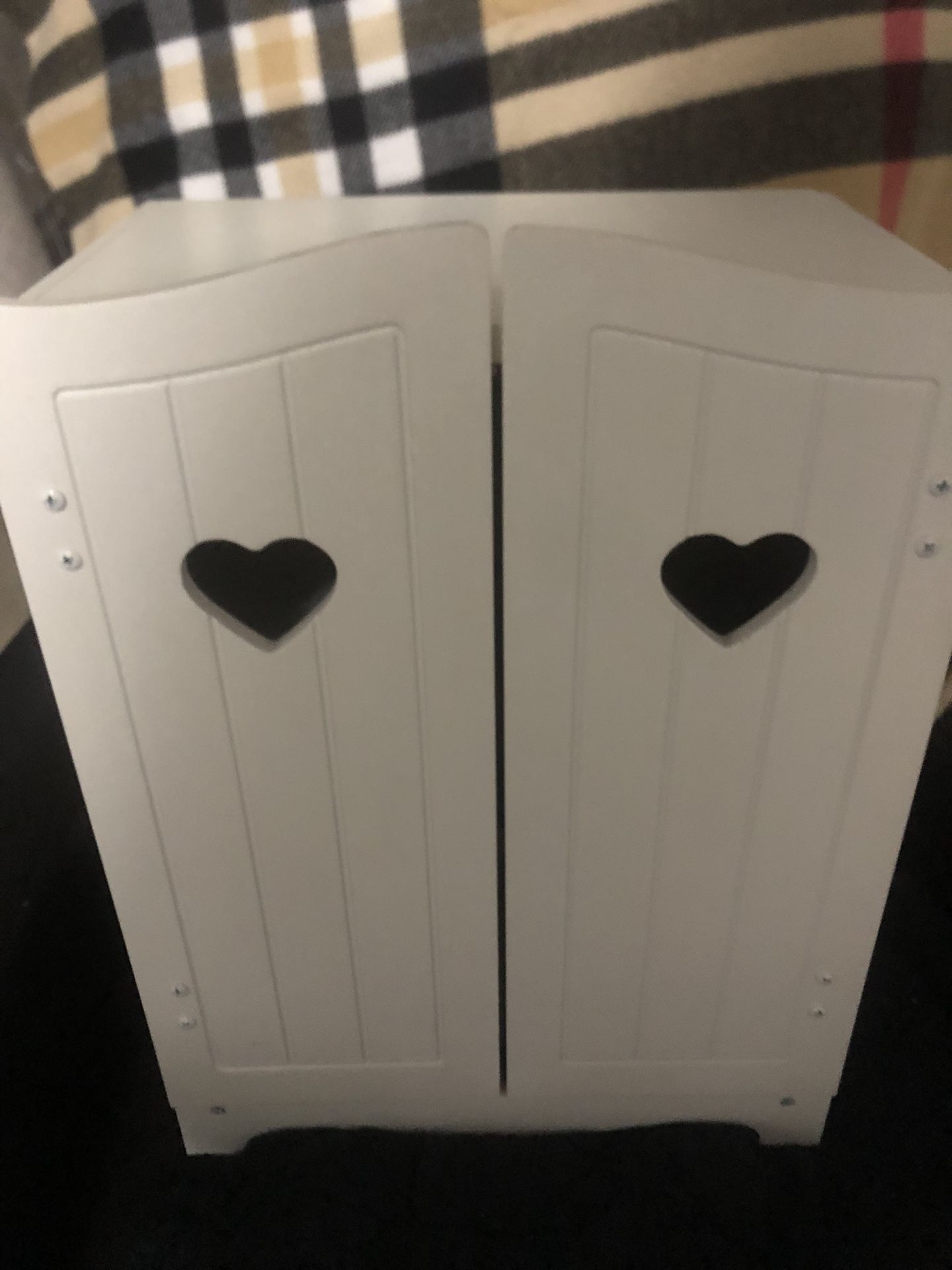 White wooden play armoire/closet for storing and organizes clothing for dolls and stuffed animals