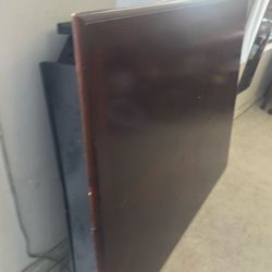 I wood table with black legs with a leaf four chairs 