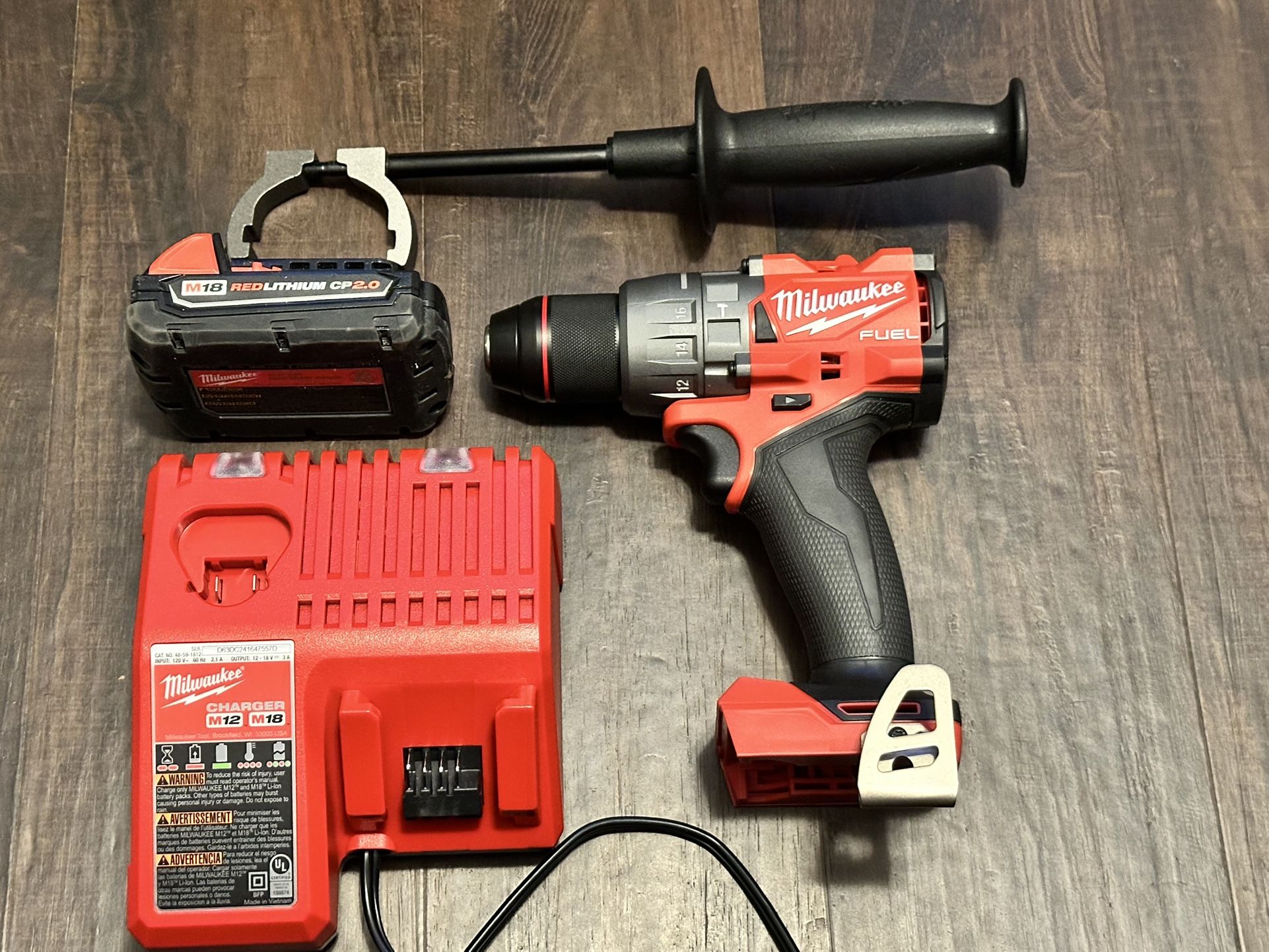 Milwaukee M18 Fuel 18-V Lithium -Ion Brushless Cordless 1/2 in. Hammer Drill Driver Kit with 1 used 2.0 Ah Batteries And New Charger