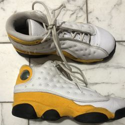 Air Jordan 13 Retro "Del Sol" sneaker in a white and university yellow colorway. 